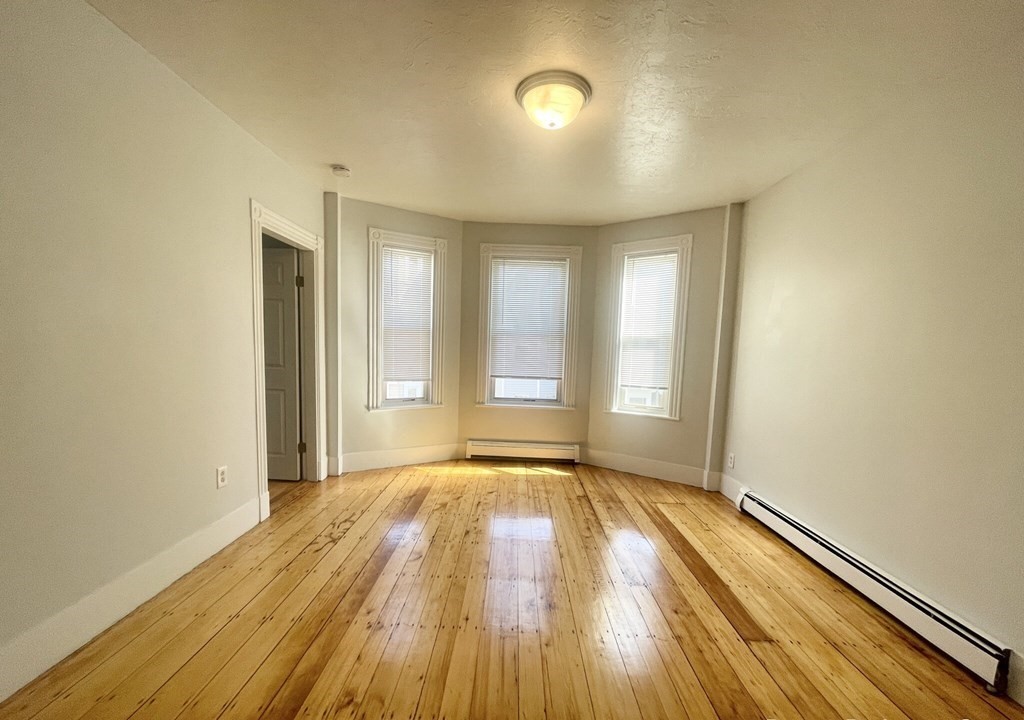 22 Howell Street, Unit 3 Boston, MA 02125 - Photo 3 of 9 a view of an empty room and window