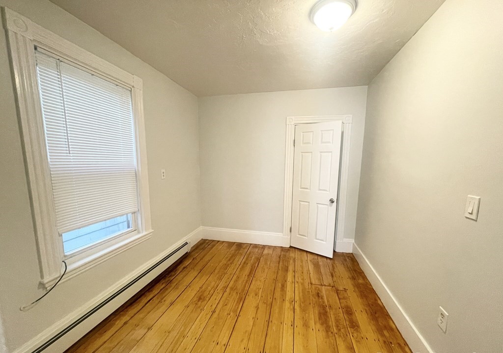 22 Howell Street, Unit 3 Boston, MA 02125 - Photo 7 of 9 a view of a room with wooden floor and window