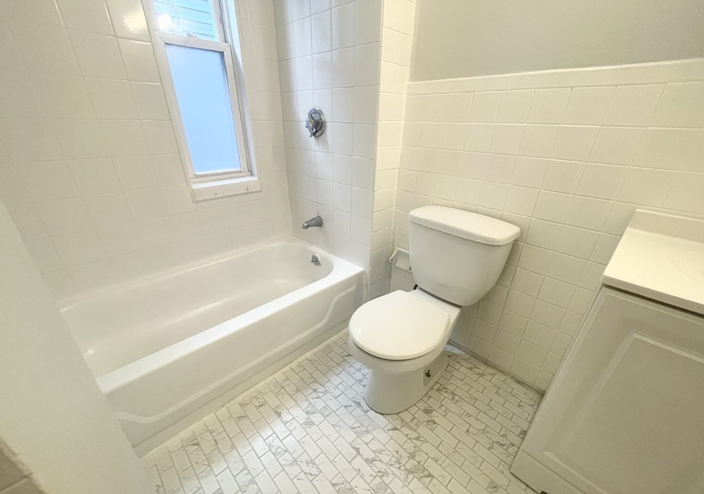22 Howell Street, Unit 3 Boston, MA 02125 - Photo 9 of 9 a bathroom with a toilet a sink and bathtub