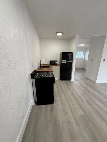 a view of a room with wooden floor