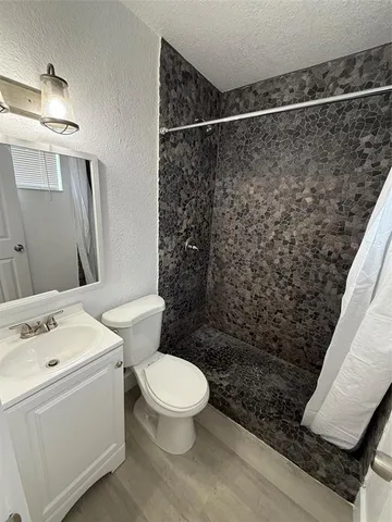 a white toilet sitting next to a bathroom sink