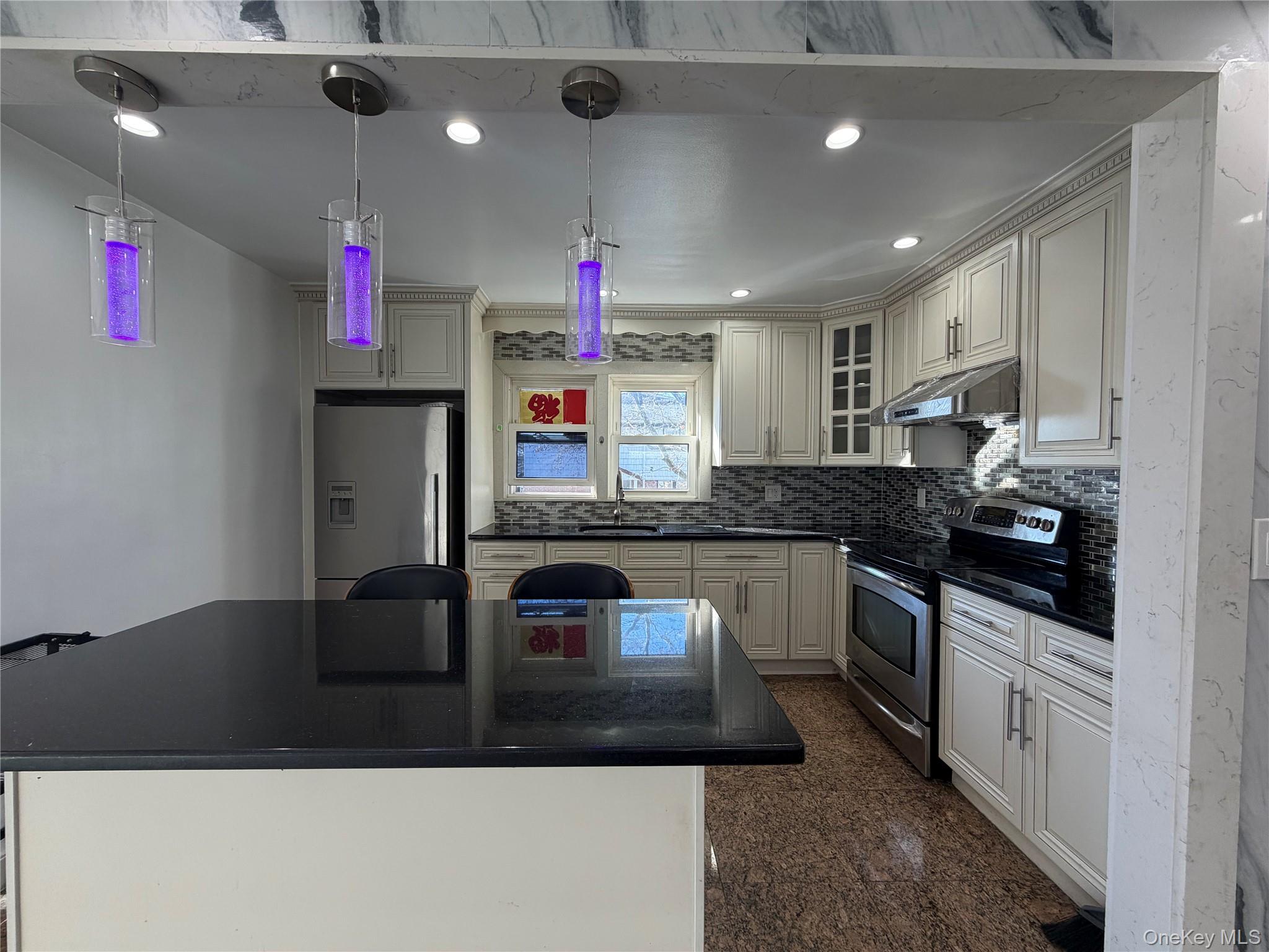 224-01 59th Avenue Queens, NY 11364 - Photo 5 of 13 a kitchen with kitchen island granite countertop stainless steel appliances sink cabinets and stove top oven