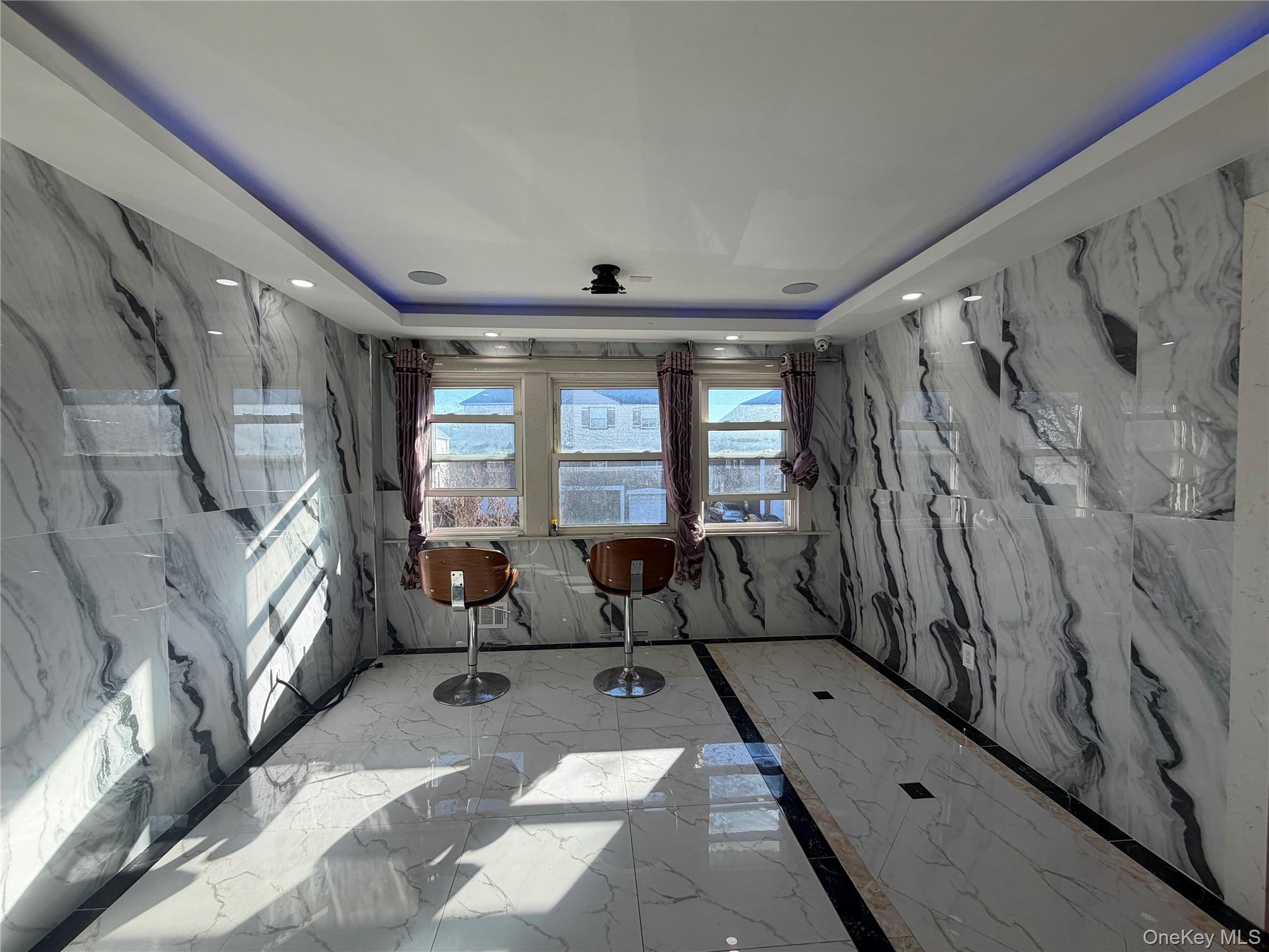 224-01 59th Avenue Queens, NY 11364 - Photo 6 of 13 a living room with furniture and a large window