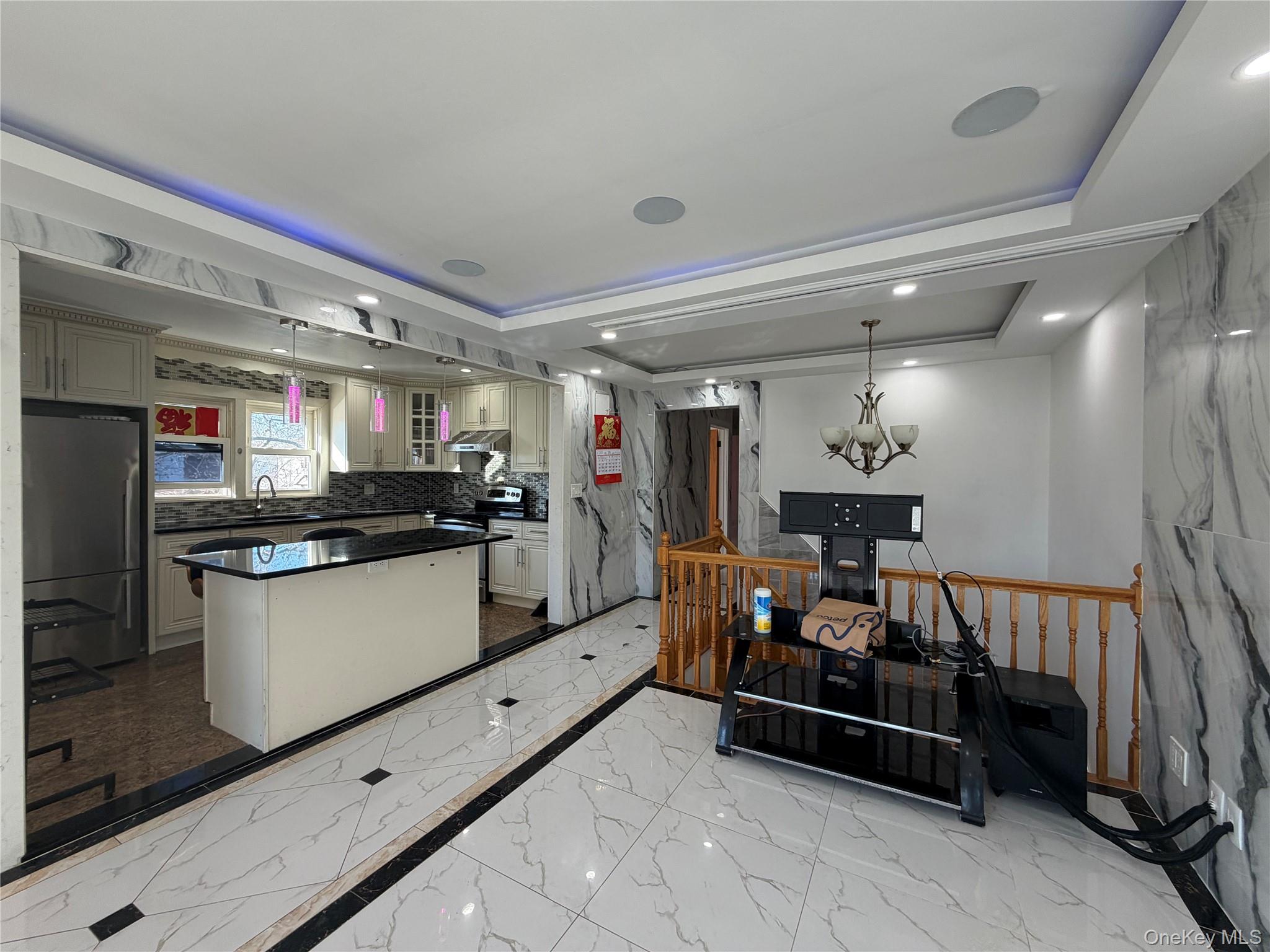 224-01 59th Avenue Queens, NY 11364 - Photo 7 of 13 a kitchen with stainless steel appliances kitchen island granite countertop a refrigerator and a stove top oven