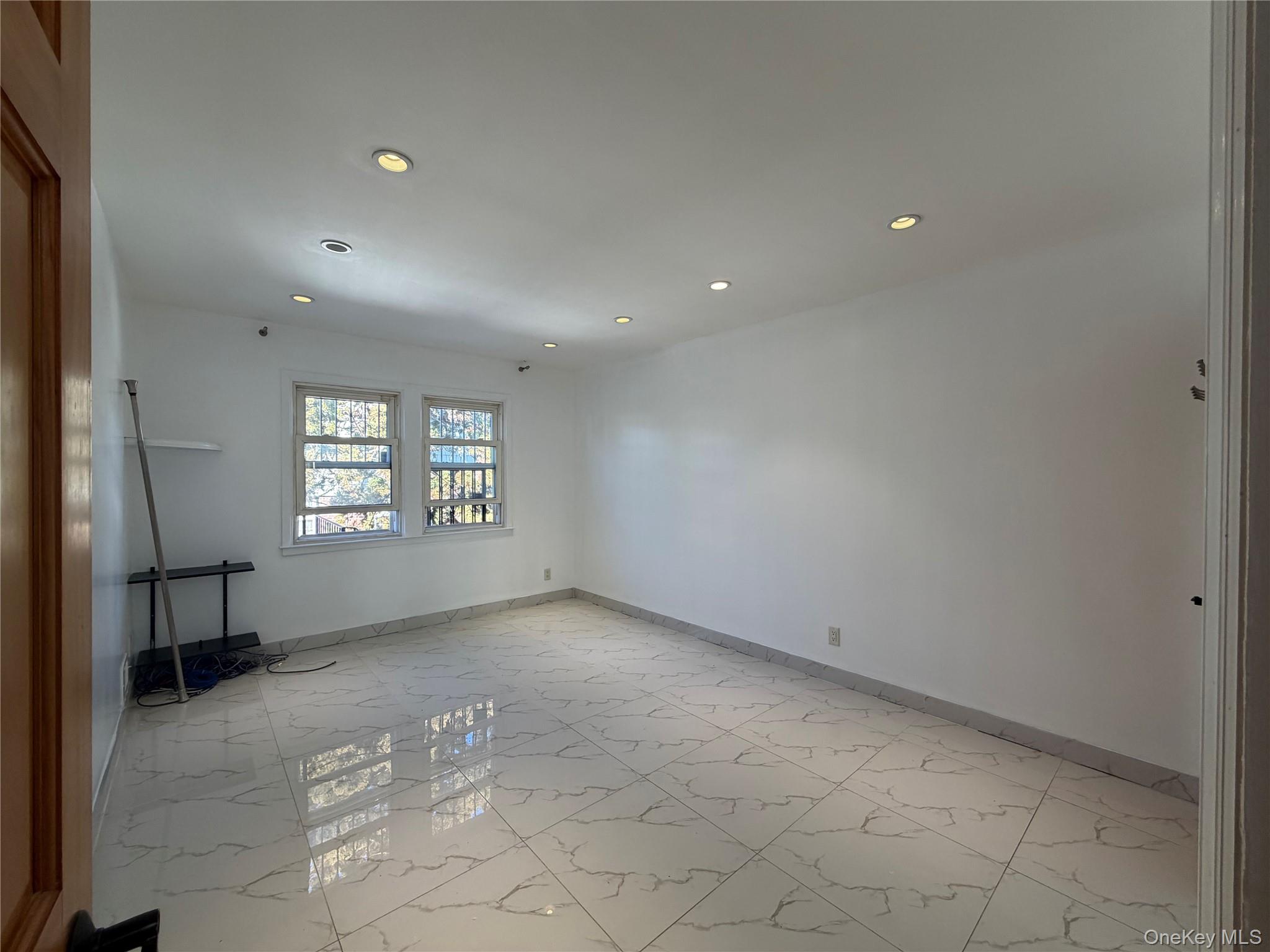 224-01 59th Avenue Queens, NY 11364 - Photo 9 of 13 an empty room with windows