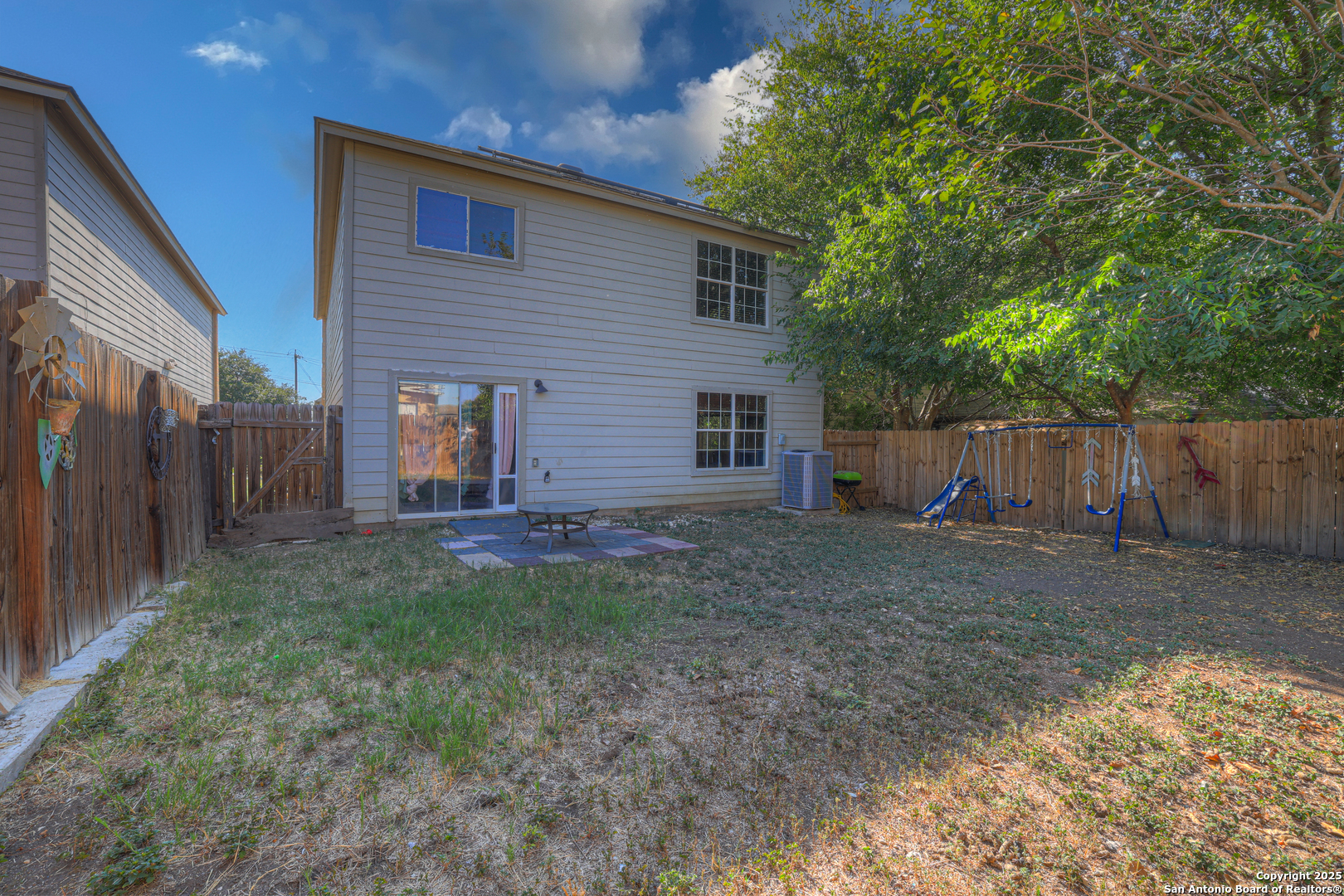 6131 Kensinger Pass Converse, TX 78109 - Photo 20 of 20 a view of a backyard with large trees and wooden fence