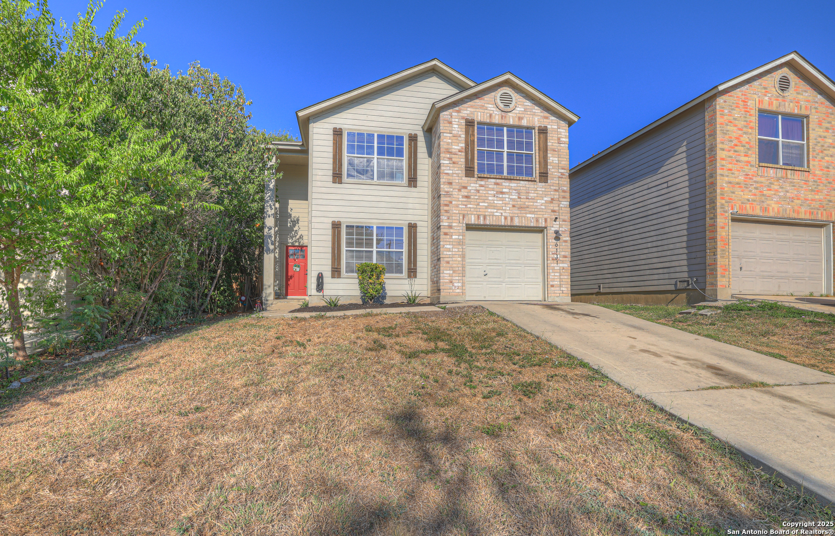 6131 Kensinger Pass Converse, TX 78109 - Photo 2 of 20 a front view of a house with a yard