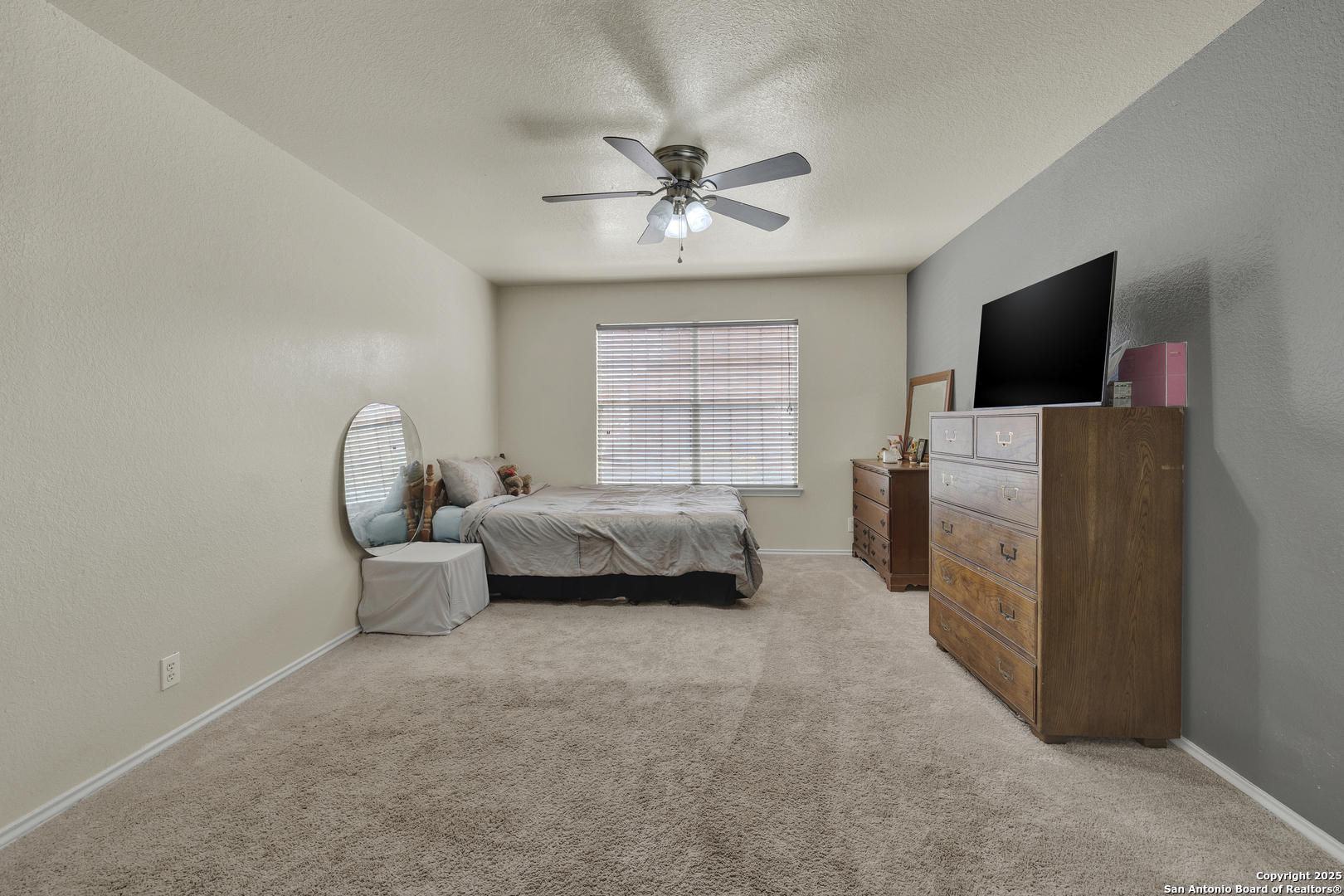 6131 Kensinger Pass Converse, TX 78109 - Photo 6 of 20 a bedroom with furniture and a flat screen tv