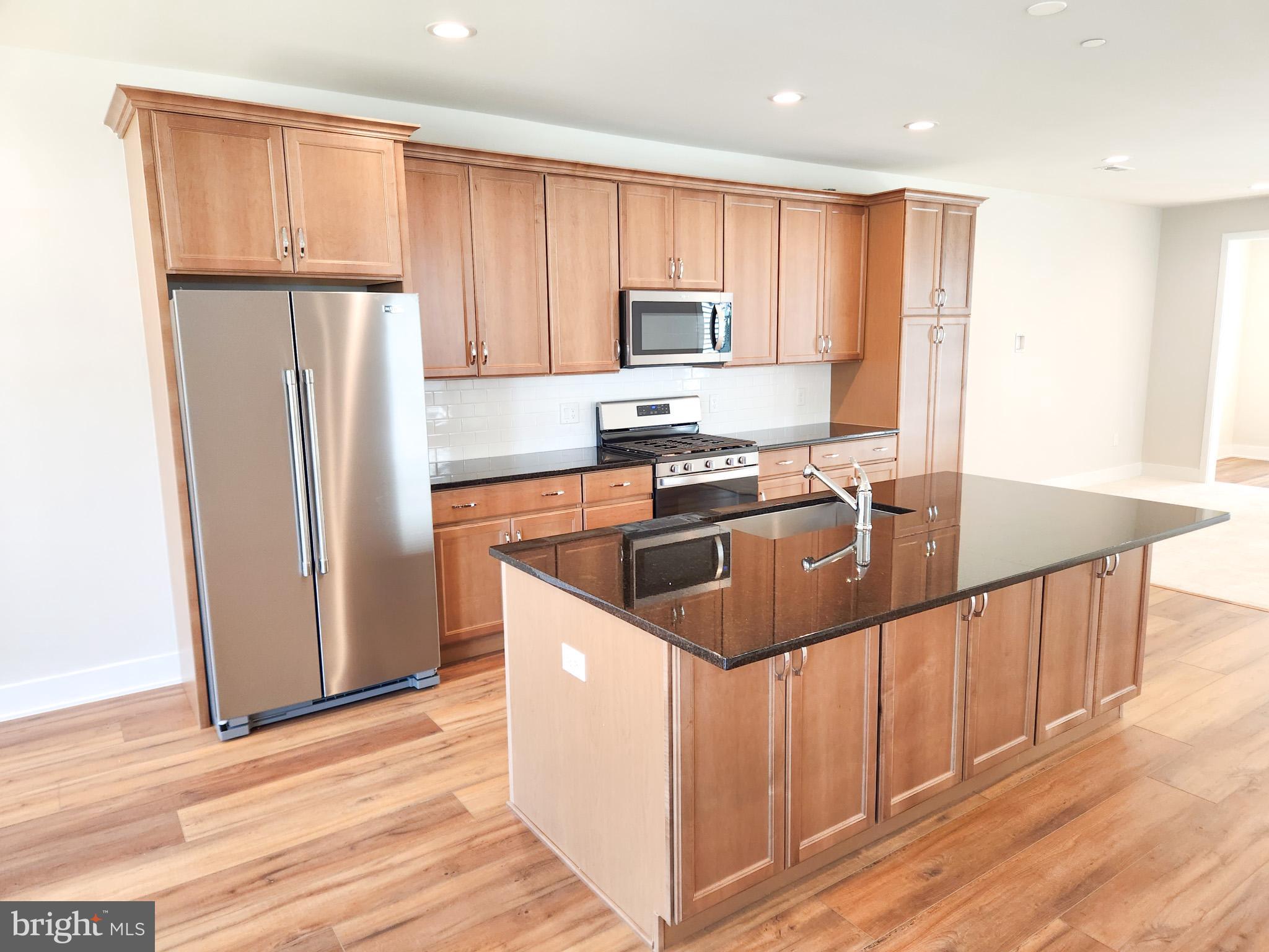 3150 Parkview Walk, Unit 213 Philadelphia, PA 19125 - Photo 1 of 21 a kitchen with stainless steel appliances granite countertop a sink a stove a refrigerator and cabinets