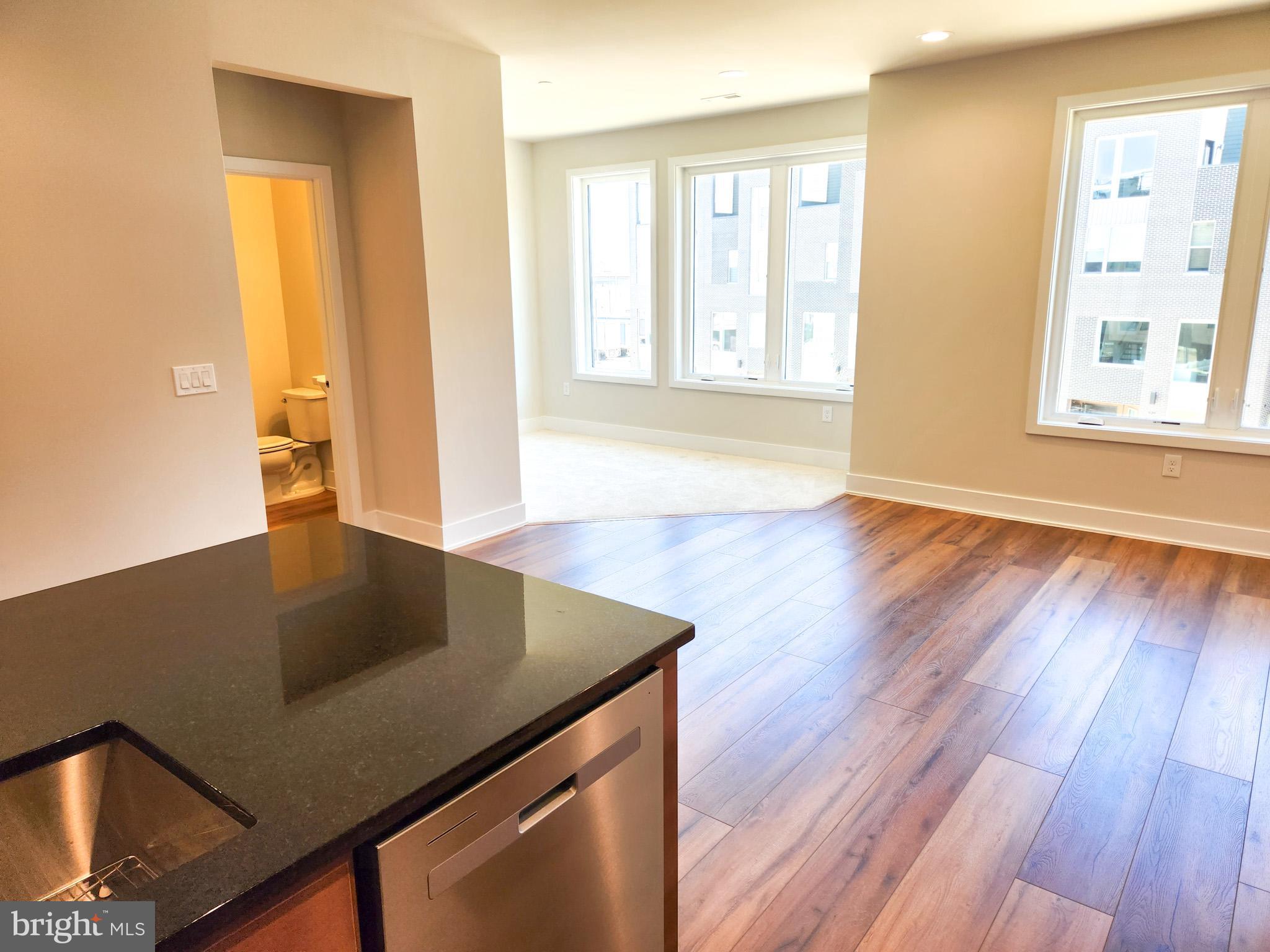 3150 Parkview Walk, Unit 213 Philadelphia, PA 19125 - Photo 3 of 21 a living room with wooden floor and large window