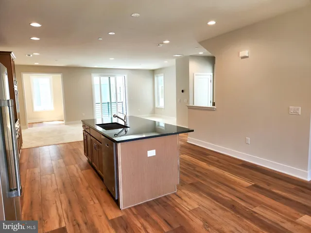 a kitchen with granite countertop a sink and a stove top oven