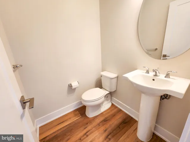 a bathroom with a sink toilet and a mirror