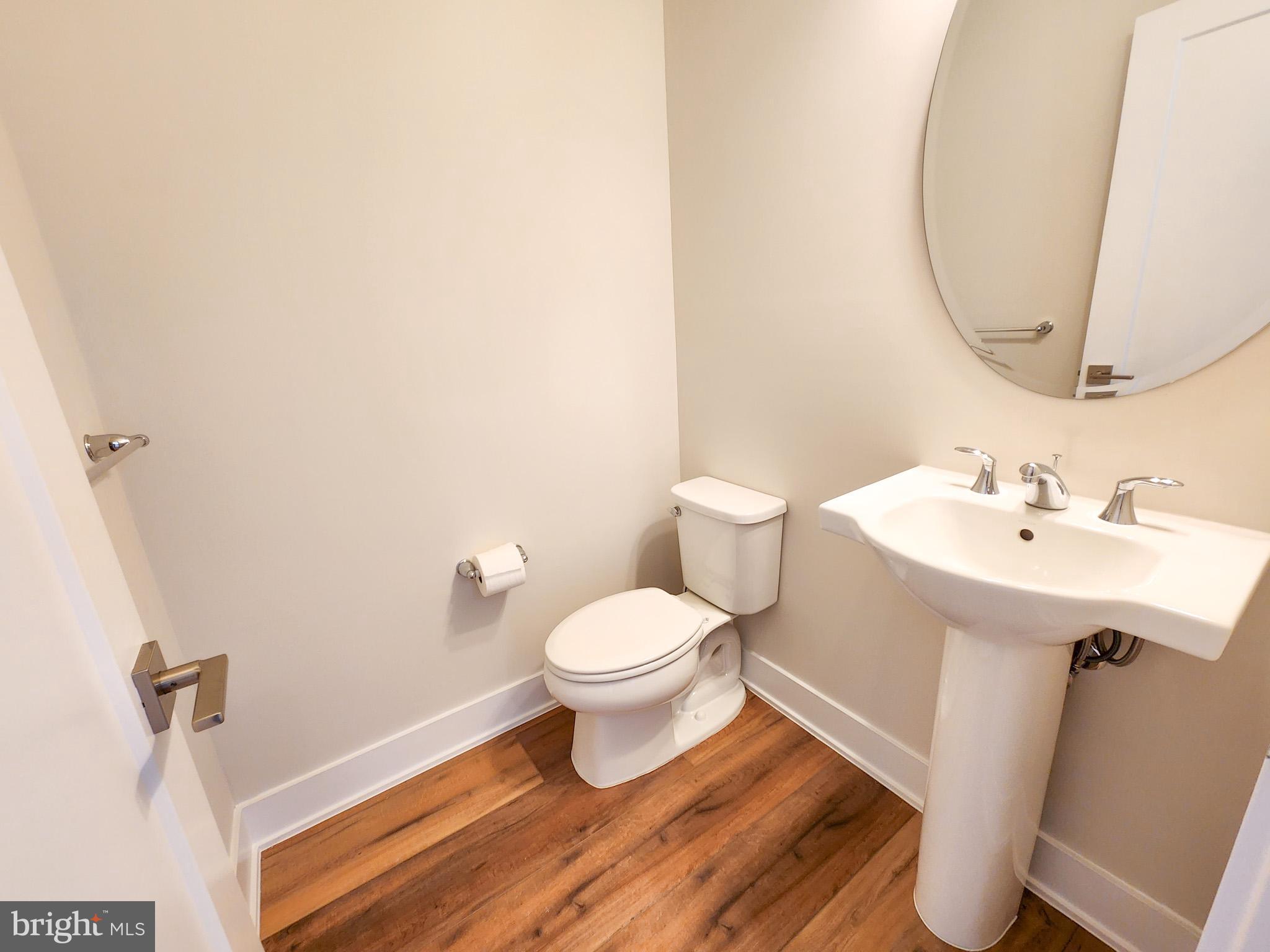 3150 Parkview Walk, Unit 213 Philadelphia, PA 19125 - Photo 7 of 21 a bathroom with a sink toilet and a mirror