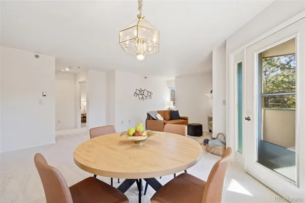 a view of a dining room with furniture and a chandelier