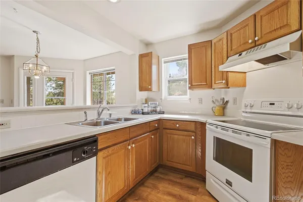 a kitchen with a sink stove and cabinets