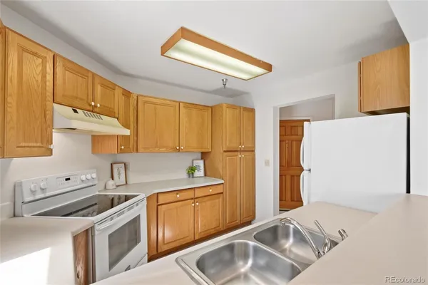 a kitchen with a sink cabinets and appliances