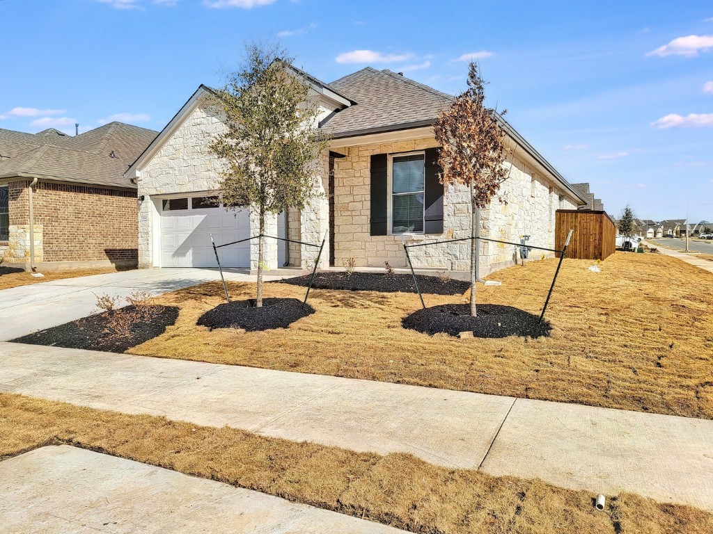 a view of a house with snow on the roadside