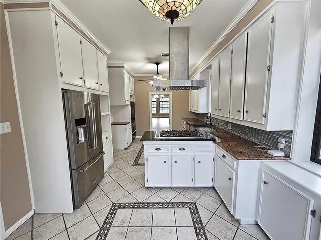 a view of an empty room with a window and fireplace