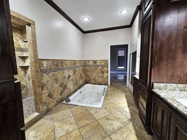 a view of a kitchen with stainless steel appliances granite countertop a stove and cabinets