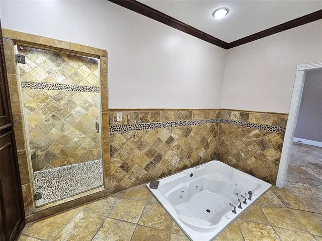 an empty room with wooden floor fireplace and windows