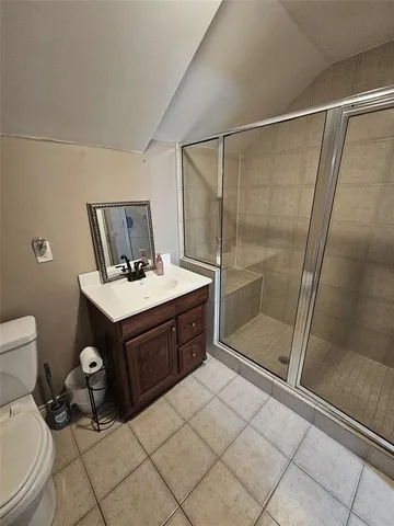 a bedroom with a bed mirror and window