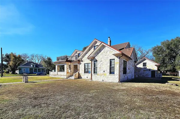 a front view of a house with a yard