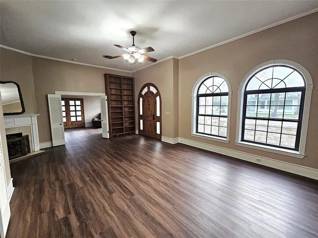 wooden floor in an empty room with a window