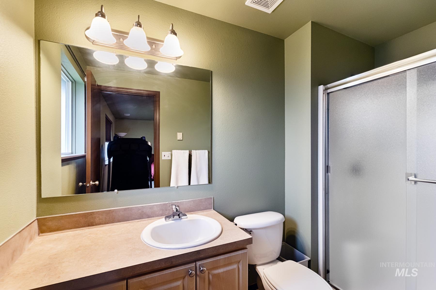 7500 Pleasant View Drive Caldwell, ID 83607 - Photo 11 of 43 Full bathroom featuring a stall shower, vanity, and a textured wall
