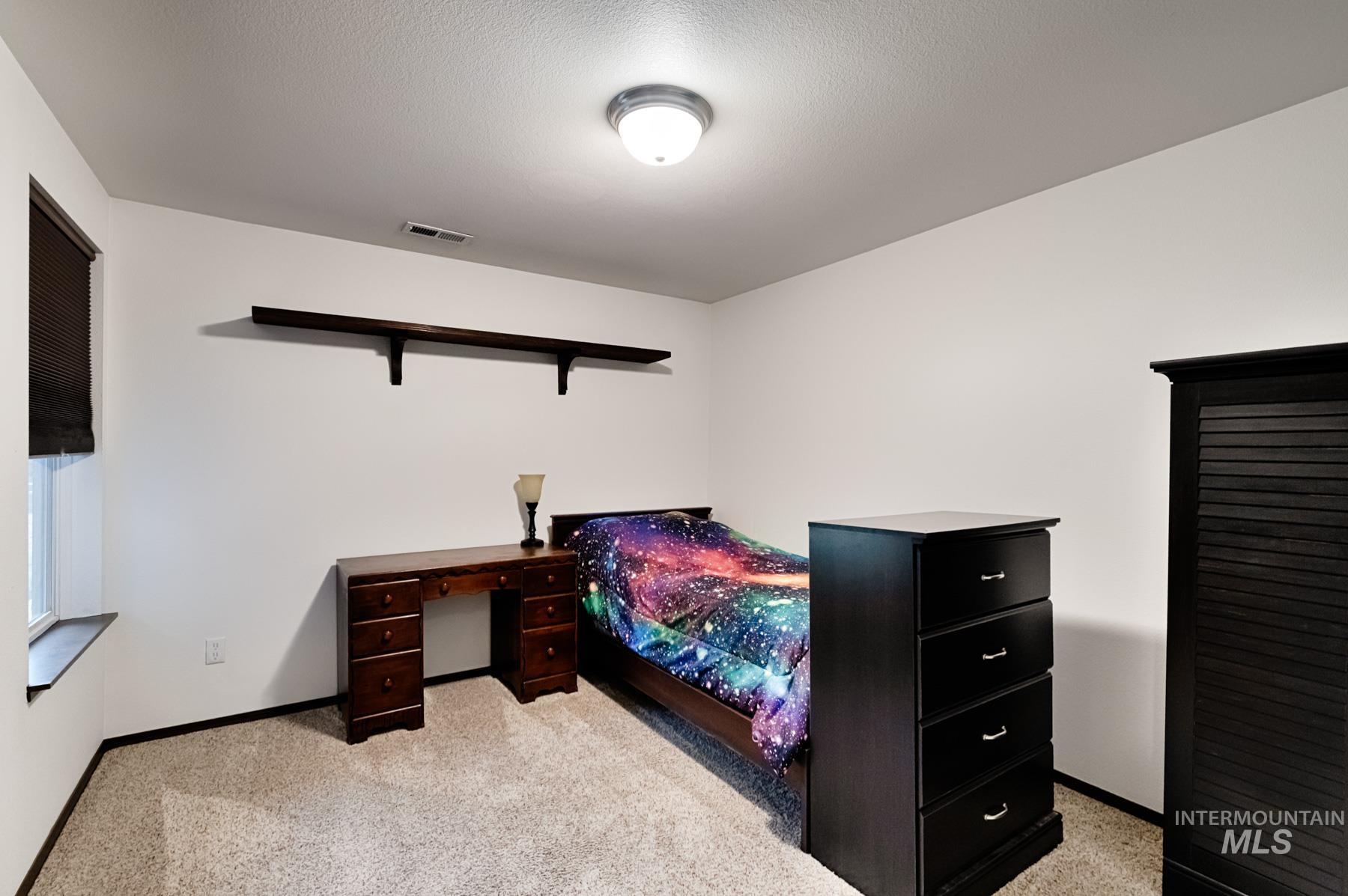 7500 Pleasant View Drive Caldwell, ID 83607 - Photo 12 of 43 Bedroom featuring light colored carpet