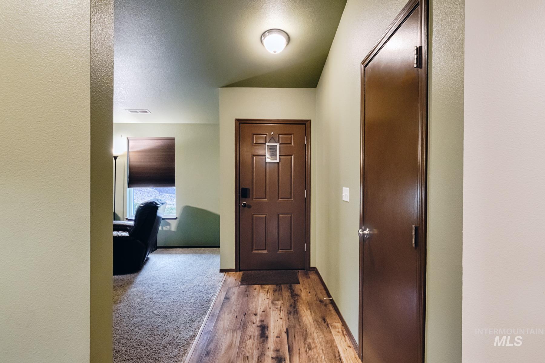 7500 Pleasant View Drive Caldwell, ID 83607 - Photo 14 of 43 Entryway featuring wood finished floors, a textured wall, and a textured ceiling