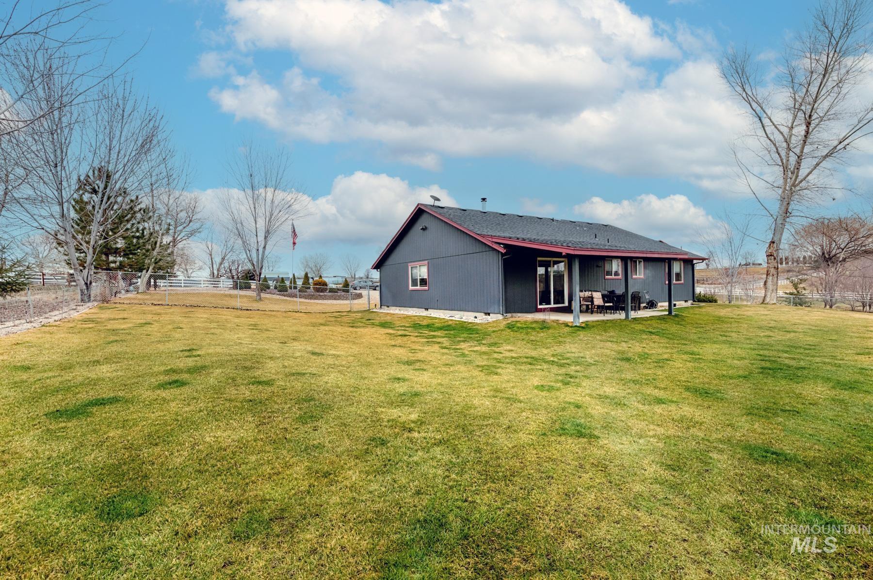 7500 Pleasant View Drive Caldwell, ID 83607 - Photo 23 of 43 Back of property with a fenced backyard and a patio area