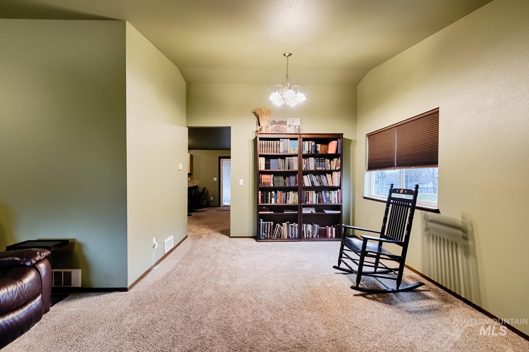 7500 Pleasant View Drive Caldwell, ID 83607 - Photo 3 of 43 Sitting room featuring hanging lights, carpet floors, and vaulted ceiling