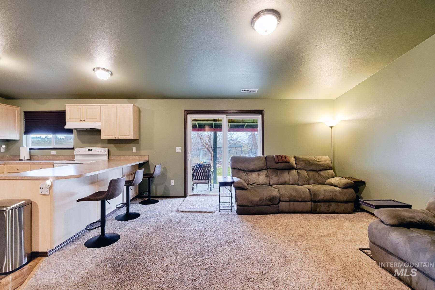 7500 Pleasant View Drive Caldwell, ID 83607 - Photo 29 of 43 Living area with light colored carpet and a textured ceiling