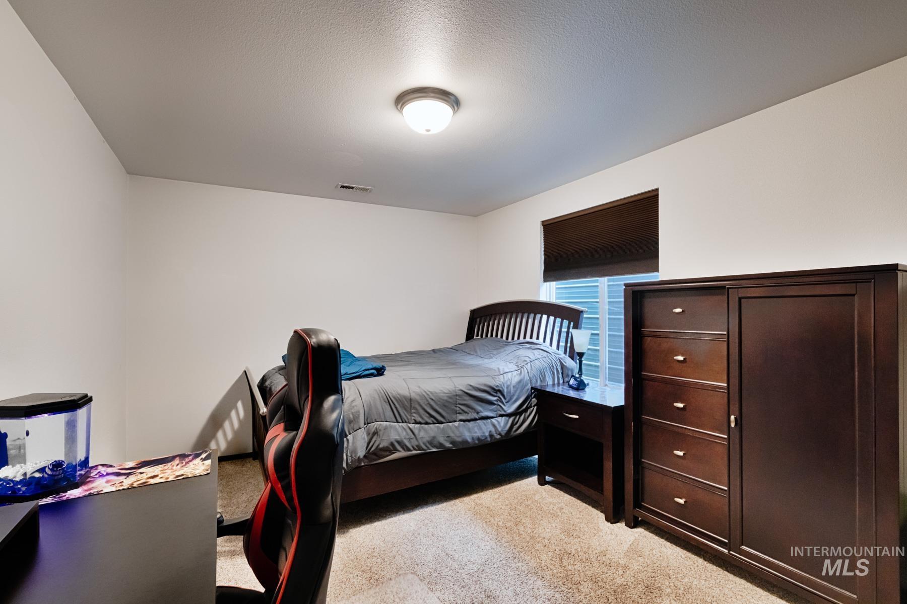 7500 Pleasant View Drive Caldwell, ID 83607 - Photo 31 of 43 Bedroom featuring light carpet