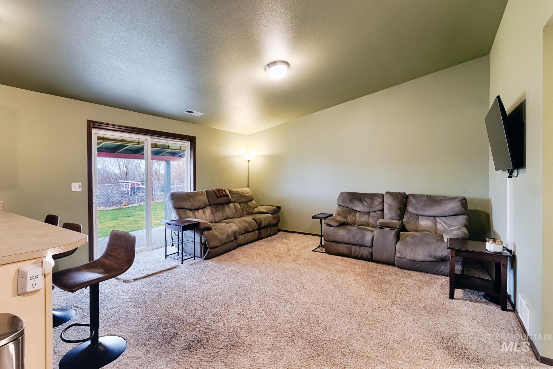 7500 Pleasant View Drive Caldwell, ID 83607 - Photo 7 of 43 Living area with light carpet and a textured ceiling