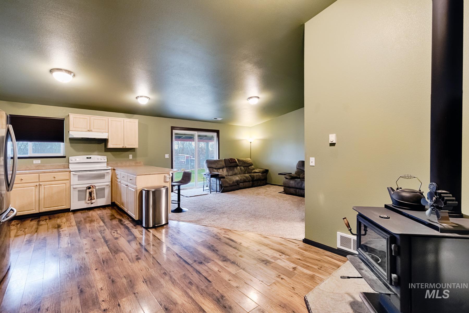 7500 Pleasant View Drive Caldwell, ID 83607 - Photo 43 of 43 Kitchen with open floor plan, light countertops, range with two ovens, a peninsula, and light wood-type flooring