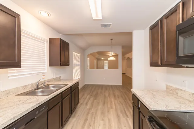 a kitchen with a sink stove and cabinets