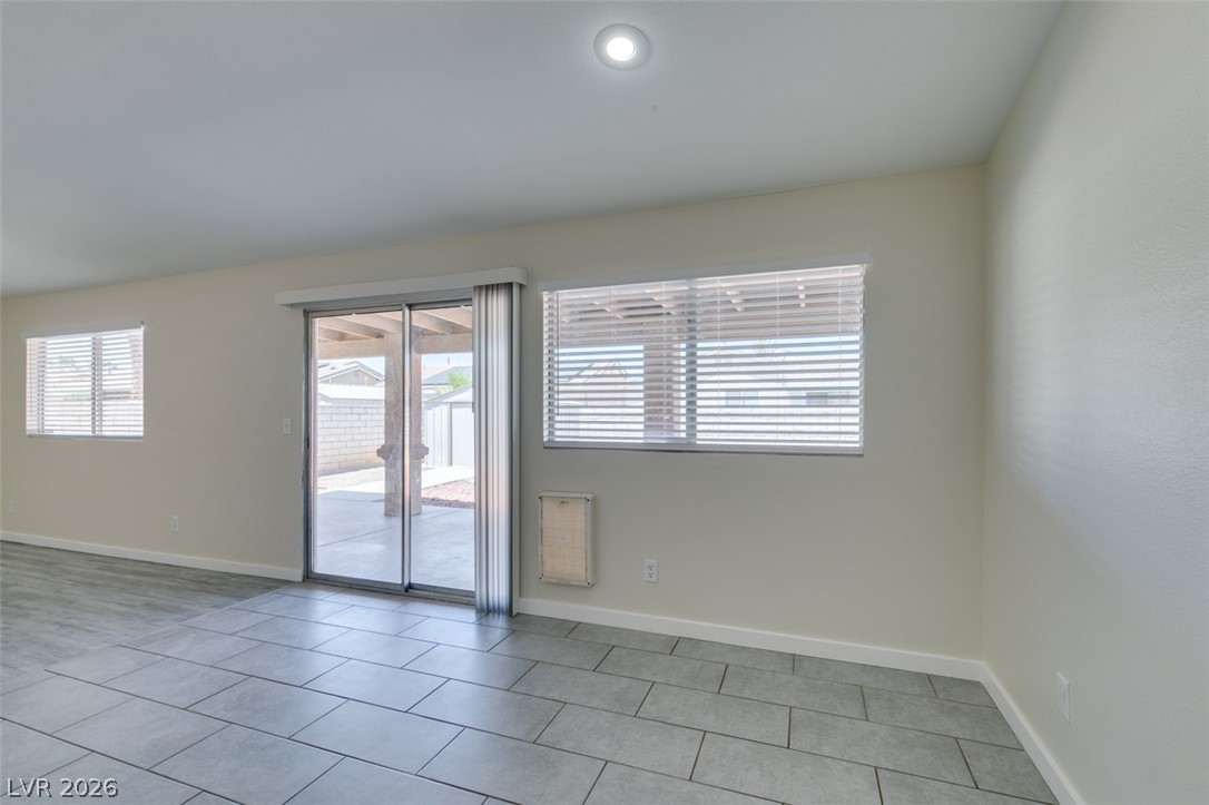 2028 Rustler Ridge Avenue North Las Vegas, NV 89031 - Photo 17 of 40 Floor-to-ceiling sliding glass doors create a seamless connection to the outdoor living area.