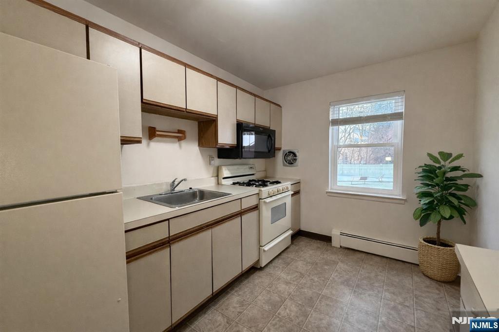55 Knox Terrace, Unit 1A Wayne, NJ 07470 - Photo 5 of 9 a kitchen with appliances a sink and a window