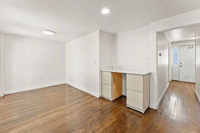 an empty room with wooden floor