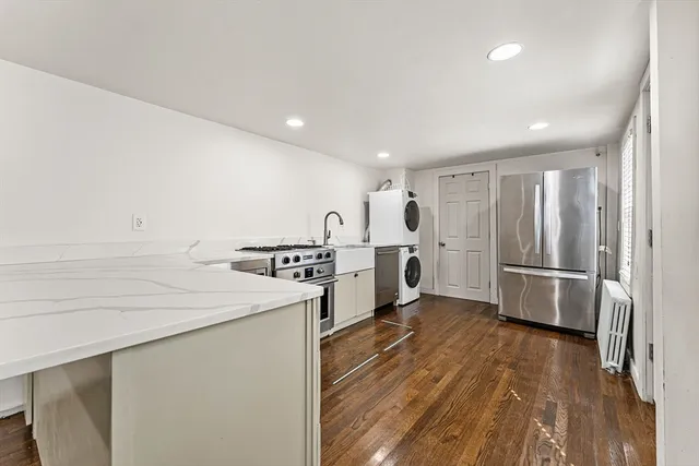 a kitchen with stainless steel appliances a refrigerator and a stove top oven