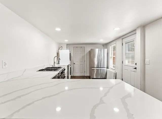 a bedroom with a bed a mirror and lamp