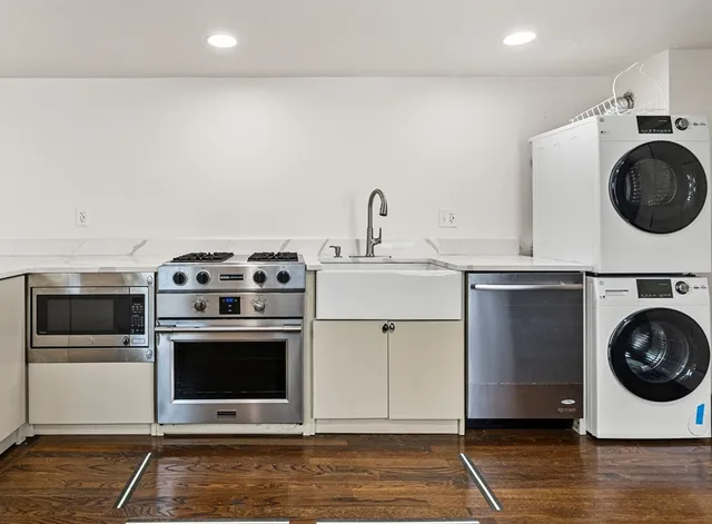 a utility room with sink dryer and washer