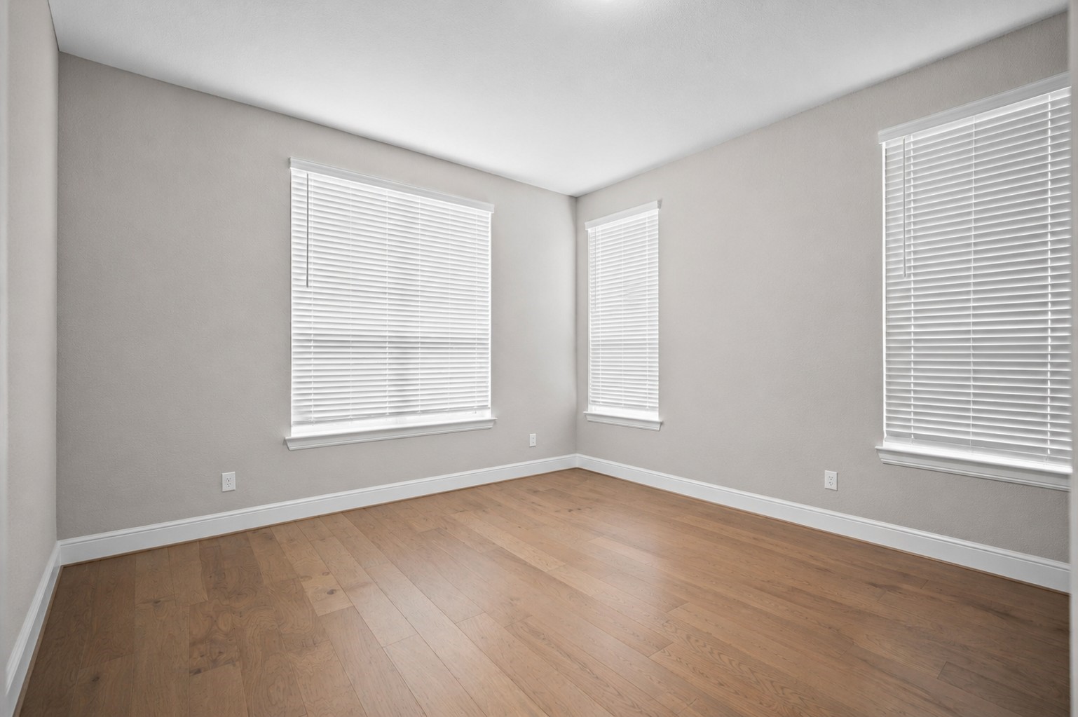 4923 Grapevine Lane Manvel, TX 77578 - Photo 28 of 49 a view of an empty room with wooden floor and a window