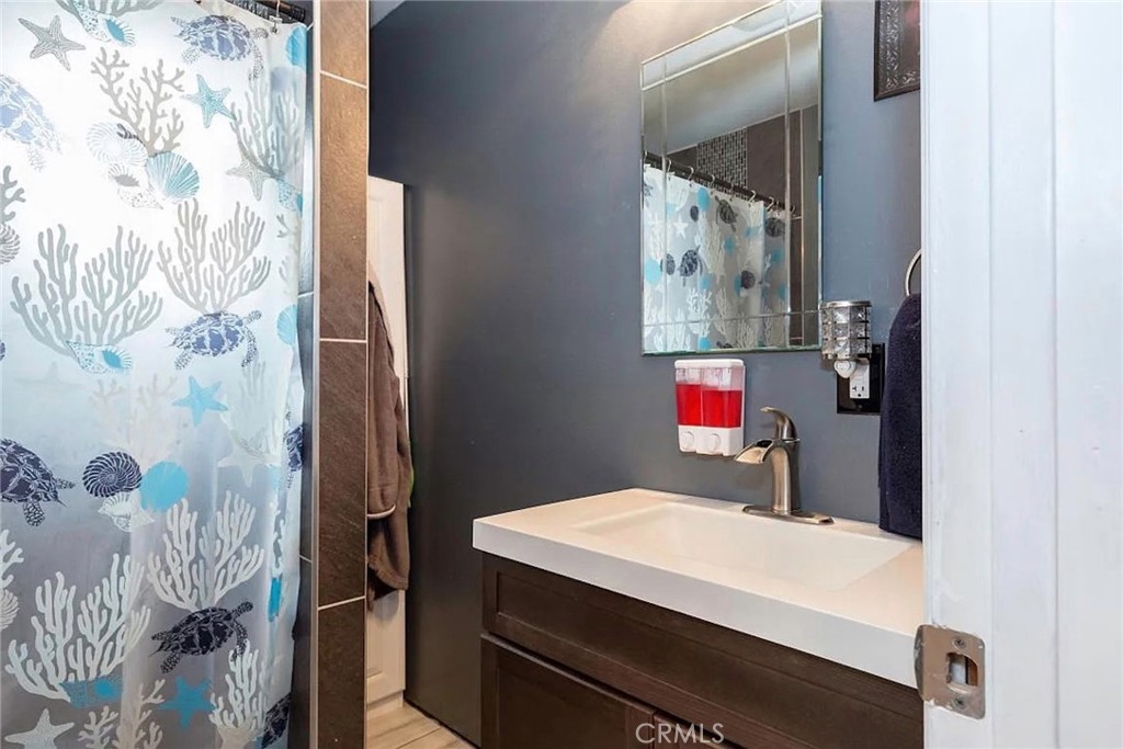 38603 Sage Tree Street Palmdale, CA 93551 - Photo 16 of 17 a bathroom with a sink and a mirror