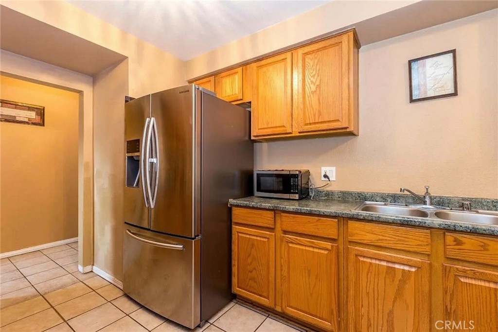 38603 Sage Tree Street Palmdale, CA 93551 - Photo 5 of 17 a kitchen with stainless steel appliances granite countertop a refrigerator and a sink