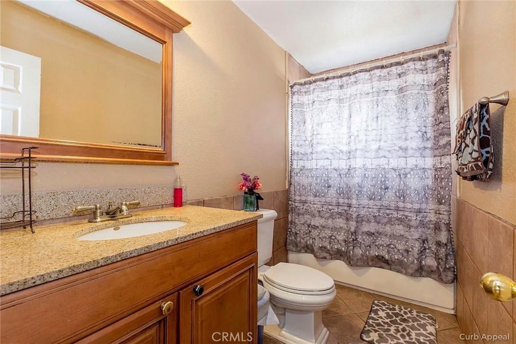 38603 Sage Tree Street Palmdale, CA 93551 - Photo 10 of 17 a bathroom with a sink a toilet and shower