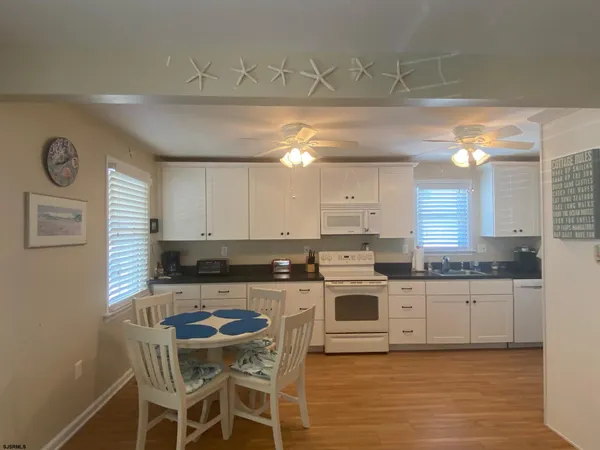 a kitchen with stainless steel appliances a stove a sink cabinets and a refrigerator