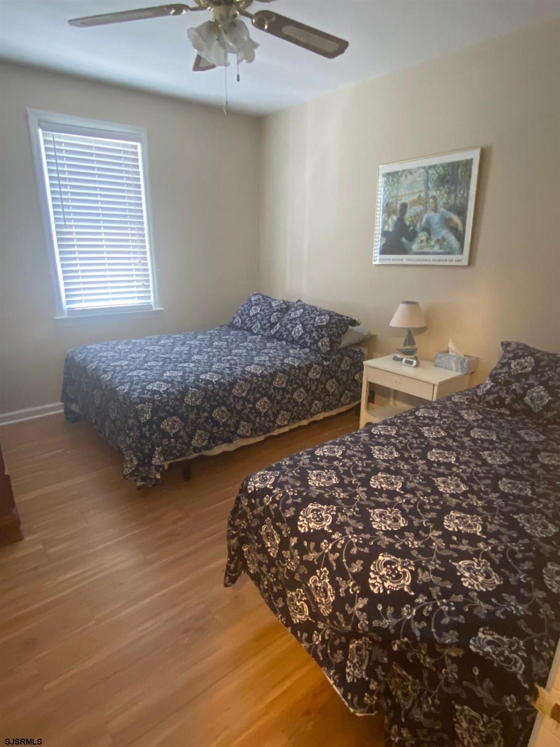 135 North Woodcrest Avenue, Unit AUGUST 15 SEPT 8 Longport, NJ 08403 - Photo 8 of 14 a bedroom with bed and window