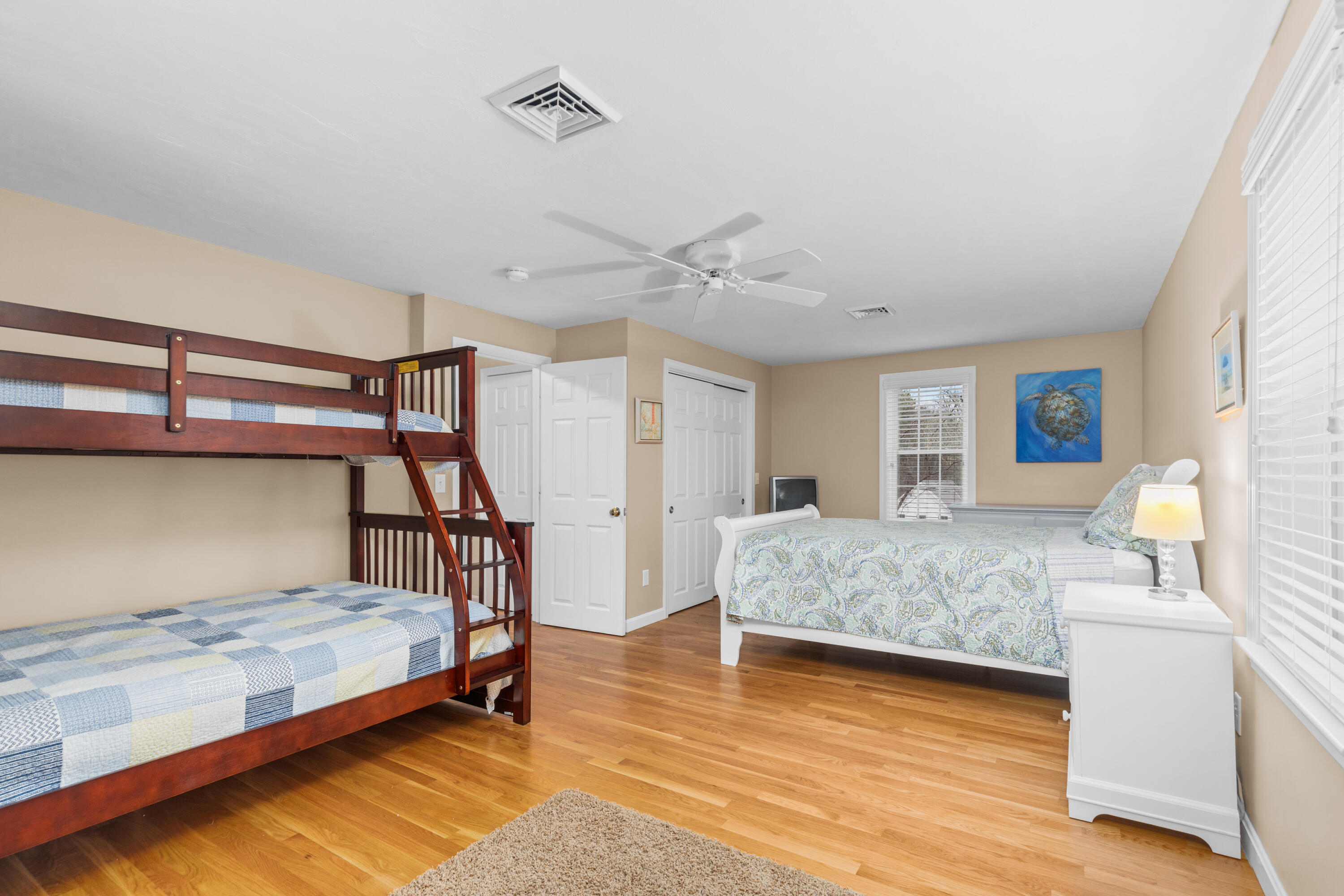 5 Baker Road Wellfleet, MA 02667 - Photo 23 of 30 a bedroom with a bed next to a window with a chandelier